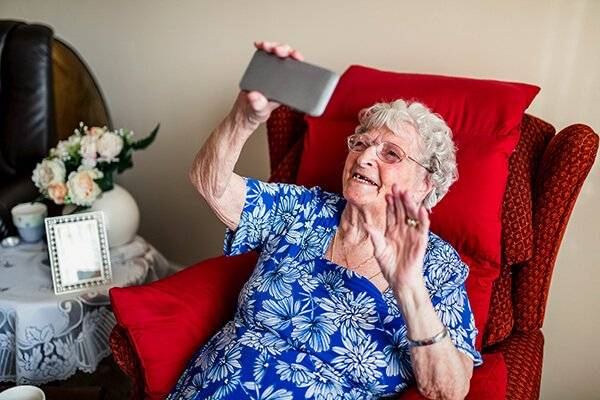 senior-woman-waving-tiny